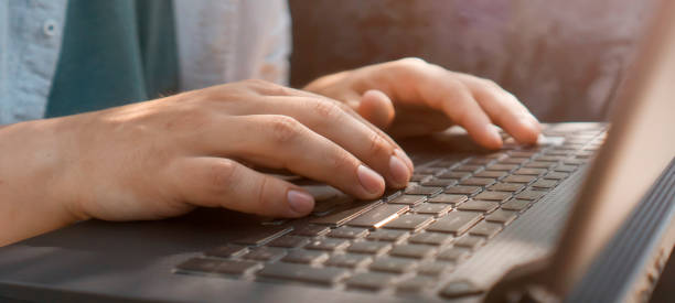istock A man works on a laptop outdoors, hands on a keyboard closeup. 2204404220