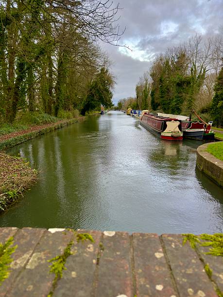 istock Narrowboats moored along a calm canal 2204406068