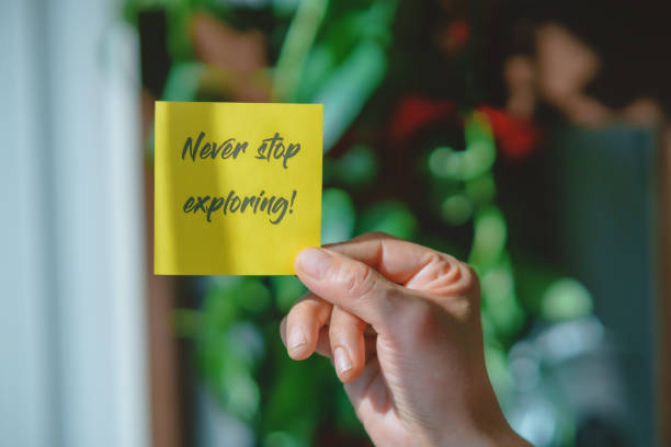 istock Colored paper note with masking tape with motivational phrases, hand holds a post it with blurred background, copy space. 2204406210