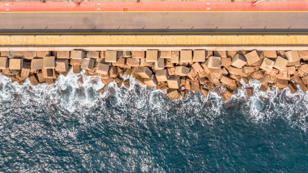 istock Pier with concrete blocks as breakwater 2204413961