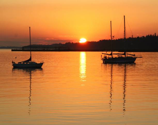 Sunrise with quiet sailboats over tahe Port Angeles harbor