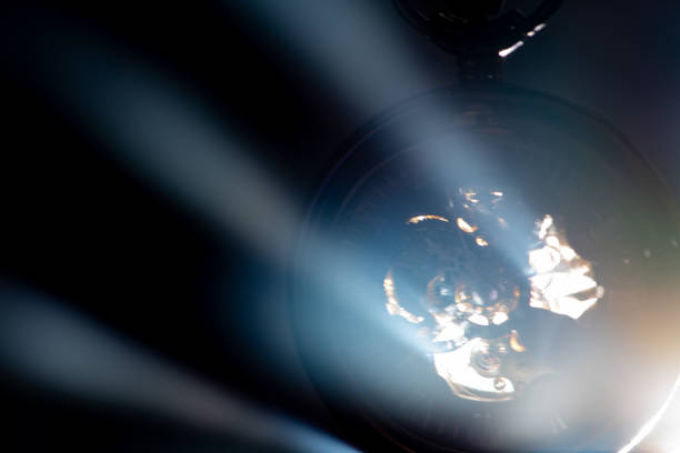 istock Antique clock, a beautiful antique clock being pierced by rays of light highlighted by smoke, selective focus. 2204422073