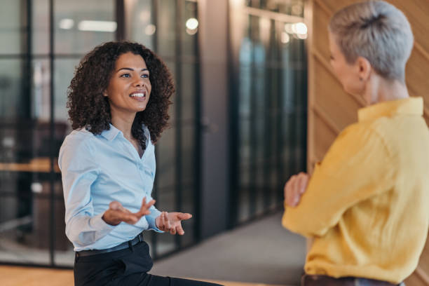 istock Two businesswomen talking in the office 2204423789