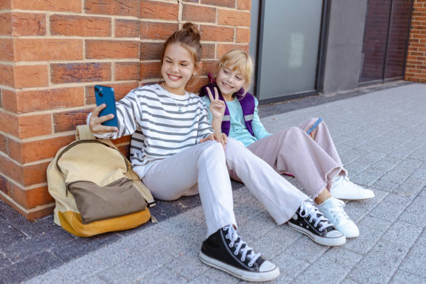 istock Two young friends taking a selfie outdoors during a leisure moment at school 2204426934