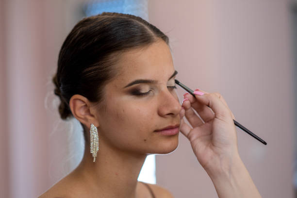 woman doing makeup beautiful women is enjoying she is happy