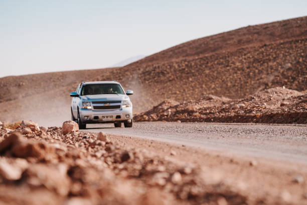 Agafay Desert, Morocco - February 16, 2025: Tourists get ready for an offroad adventure in Agafay Desert with clear skies.