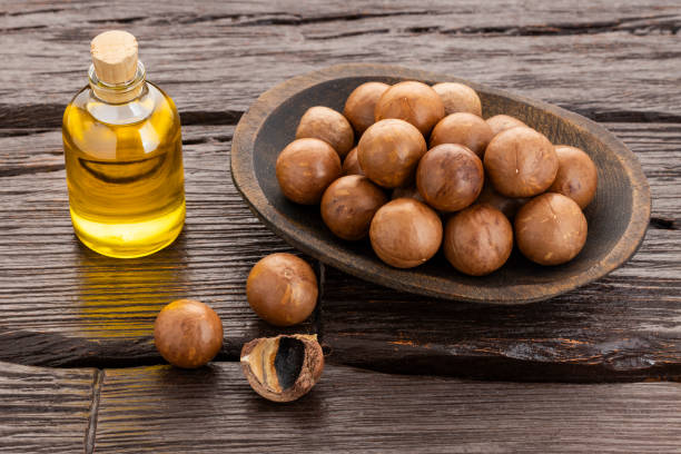 istock Natural oil and macadamia nuts - Macadamia integrifolia. 2204435847