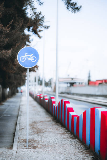 istock Bicycle lane sign with urban barrier 2204439976