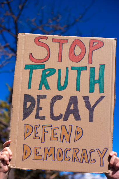 istock Person Holding Protest Sign: Stop Truth Decay 2204443151