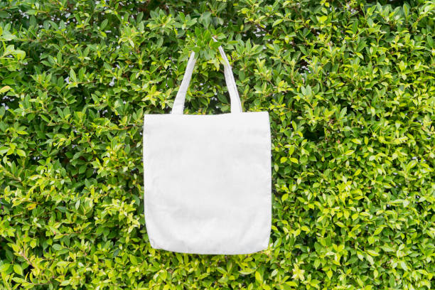 istock Blank canvas tote bag on a green foliage background with Copy Space for text or graphics. 2204445412