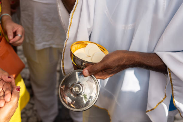 istock Catholics receive the host during mass on the last Friday of 2024. 2204449459