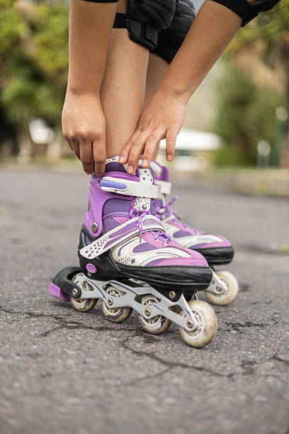 istock Adjusting Purple Skate Seen from Knees Down 2204450456