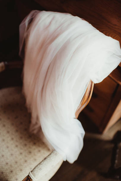 Bride's veil draped over chair before wedding ceremony