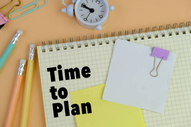 istock Time To Plan, the phrase is written on multi-colored stickers, on a brown wooden background. Business concept, strategy, plan, planning. 2204451100