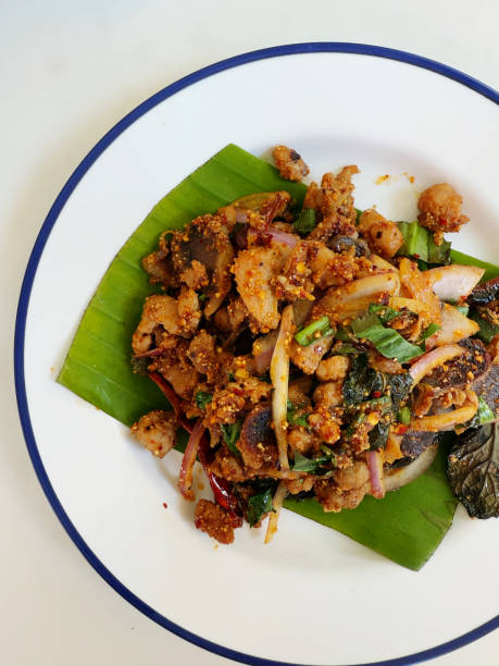 istock Thai food,Fried pork with garlic and basil on white background 2204453608