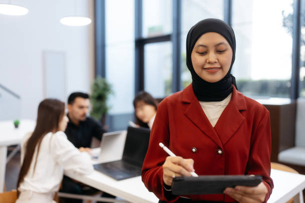 istock Malay businesswoman using digital tablet in office 2204459202