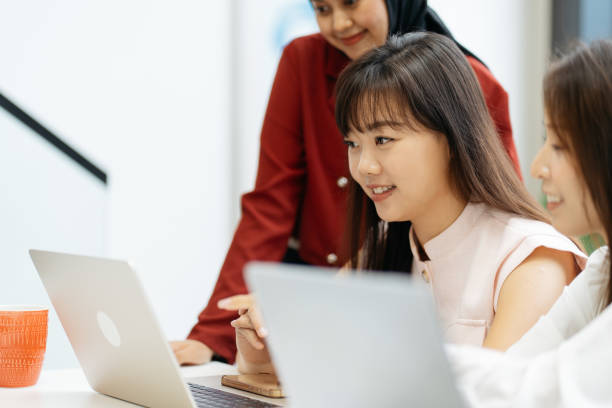 istock Asian business people working together in modern office 2204460106