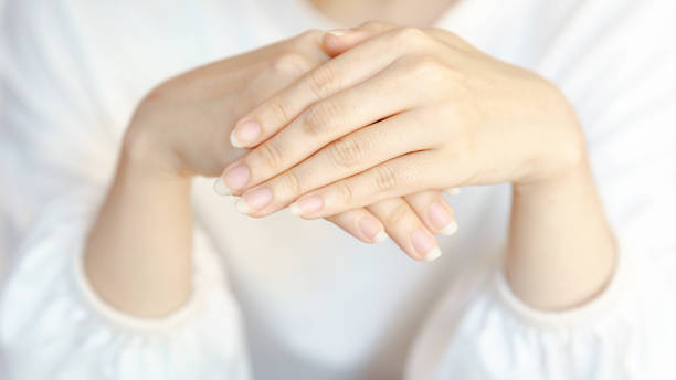 istock A close-up of elegantly positioned hands, showcasing a soft, delicate appearance with light skin tones against a neutral backdrop. 2204462098
