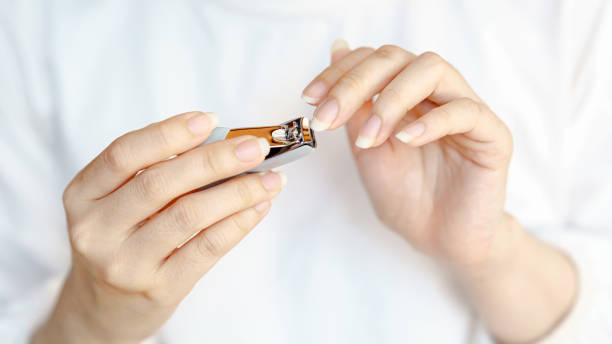 istock A person holds a small object, possibly a tool or accessory, with focus on their hands and the item, set against a light background. 2204462244