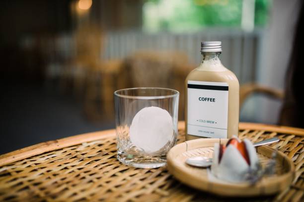 Enjoy a delightful scene featuring refreshing cold brew coffee served with ice and accompanied by sweet treats on a rustic wooden table. Ideal for casual dining.
