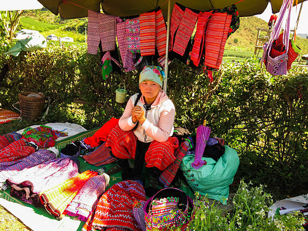 Moc Chau, Son La, Vietnam - November 28, 2016: A woman selling brocade costumes at Moc Chau market