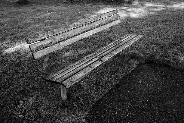 Park bench for pedestrians in black and white