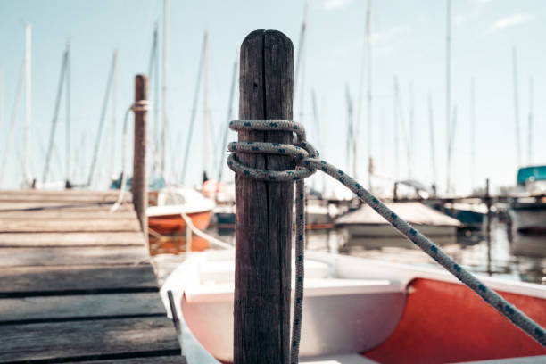 Close-up of Nautical Rope on a Moored Boat with Bright Sun Glare in Marina