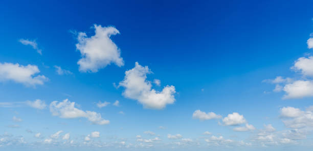 istock Bright blue sky with fluffy white clouds on a sunny day 2204466077
