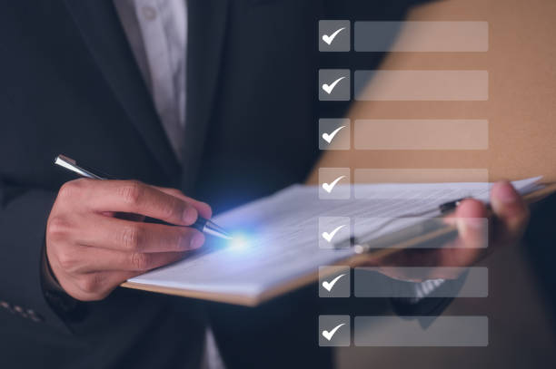 istock Businessman holding clipboard documents reports papers reading or reviewing business performance report checking documentation checklist, questionnaire survey, data management, application 2204467773