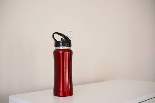 istock A Stylish Red Water Bottle Placed on a White Surface, Perfect for OntheGo Drinks or Workouts 2204468077
