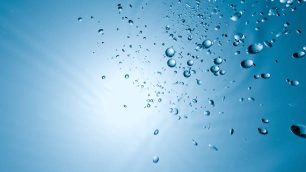 istock Bubbles ascend gracefully through clear blue water as sunlight filters in from above, creating a tranquil and serene atmosphere within the aquatic landscape. 3d render 2204470711