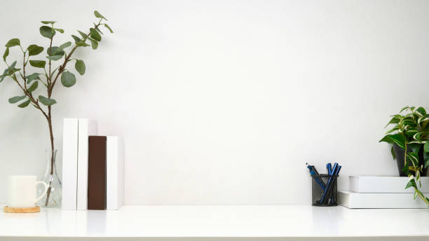istock Minimalist workspace with books, a pen holder, and green plants 2204470902