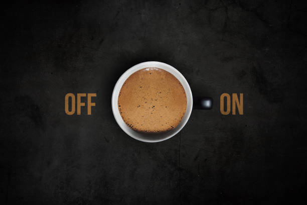 istock Top view of a coffee cup with ON and OFF text on dark background 2204471934