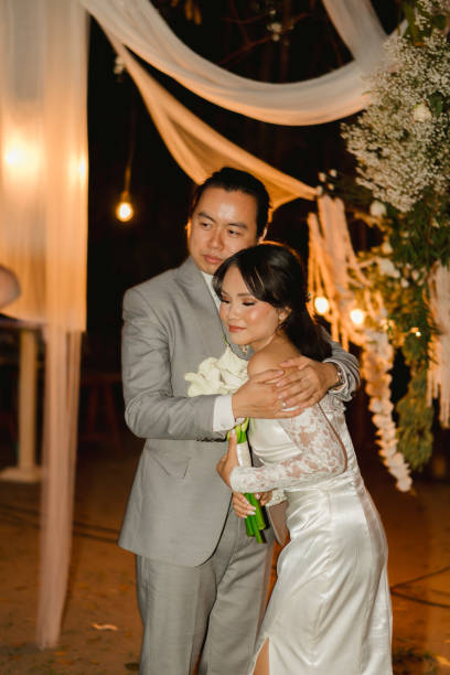 istock Romantic Wedding Embrace Under Elegant Draped Canopy with Warm Lighting 2204472111
