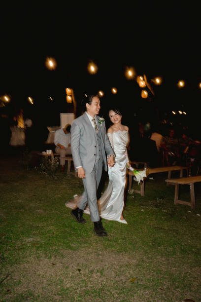istock Newlywed Couple’s Joyful Walk Under Romantic Night Lights 2204472168
