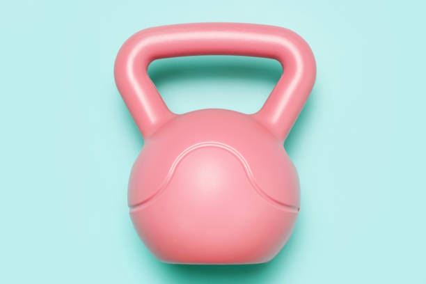 istock Pink kettlebell on a blue background top view close-up. 2204472861