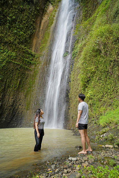 istock small group of happy young asian people exploring waterfall 2204475714