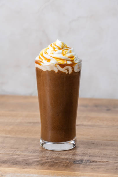 istock Caramel Frappe on a Wooden Table 2204475819