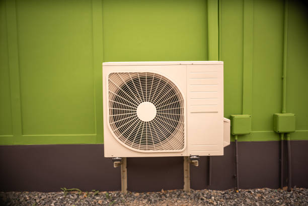 istock Air Conditioning Unit on Vibrant Green Wall for Modern Spaces 2204476659
