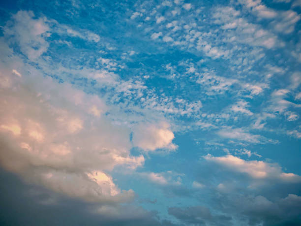 istock A serene daytime sky with fluffy white clouds scattered across a bright blue expanse. Different cloud formations create a beautiful and peaceful skyscape. 2204476734