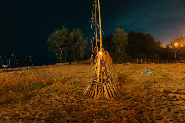 Wigwam Made from wooden branches on the sand of baltic sea beach. Multicolored summertime outdoors.