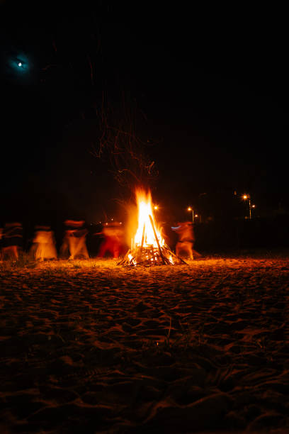 istock The crowd gathered around the bonfire for a gathering 2204477088