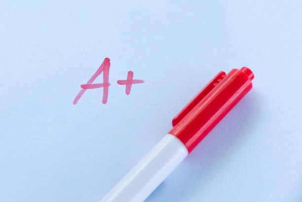 A+ Grade on Exam Paper with Red Pen on White Background