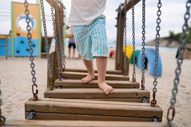 An unrecognizable little boy having fun on a playground.