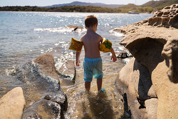 Little boy on the rocky beach.