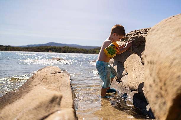 Little boy on the rocky beach.