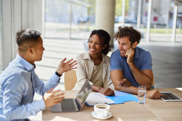 istock Diverse couple talking to their agent on a meeting in the office. 2204480977