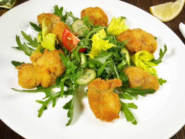 istock Breaded Veal Appetizer on green Rucola Lettuce and Vegetables 2204481253