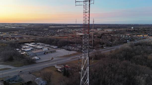 istock Top Of A Radio Tower Antenna Stack With City Background At Sunset 2204484295