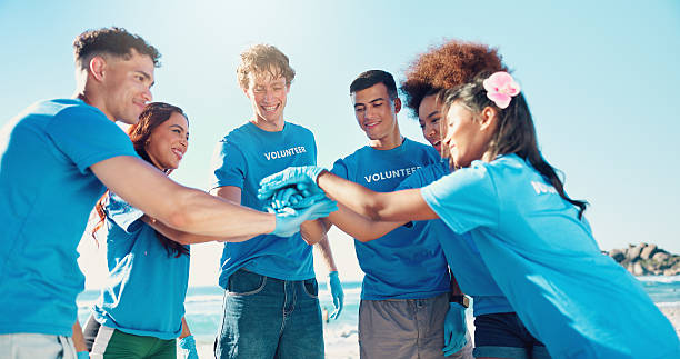istock Beach, volunteer and people with hands together for support, motivation and community service. Climate change, pollution and recycling team for ocean clean up, collaboration and social responsibility 2204484377